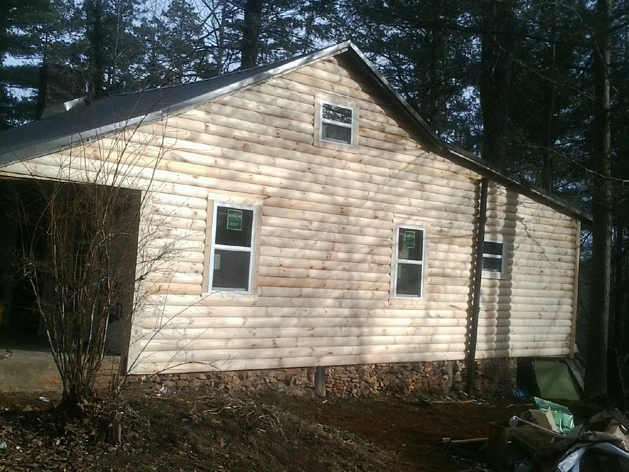 New log siding and dark metal roofing on a gable end in Southgate