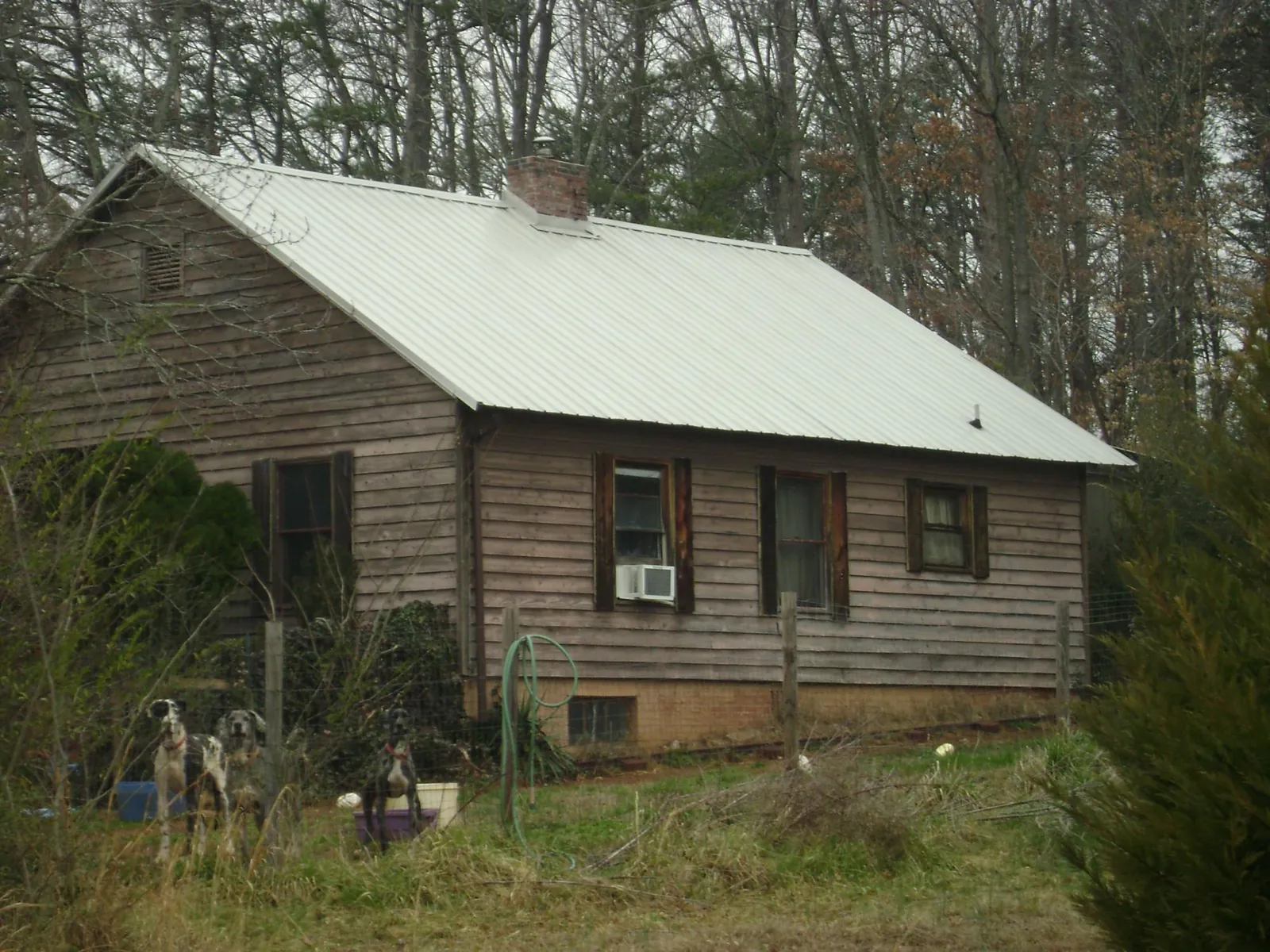 White metal roof on an old wood sided farmhouse, from a Metal Roof Installation job in Southgate